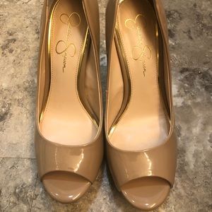 Tan patent leather platform peep toed pumps.